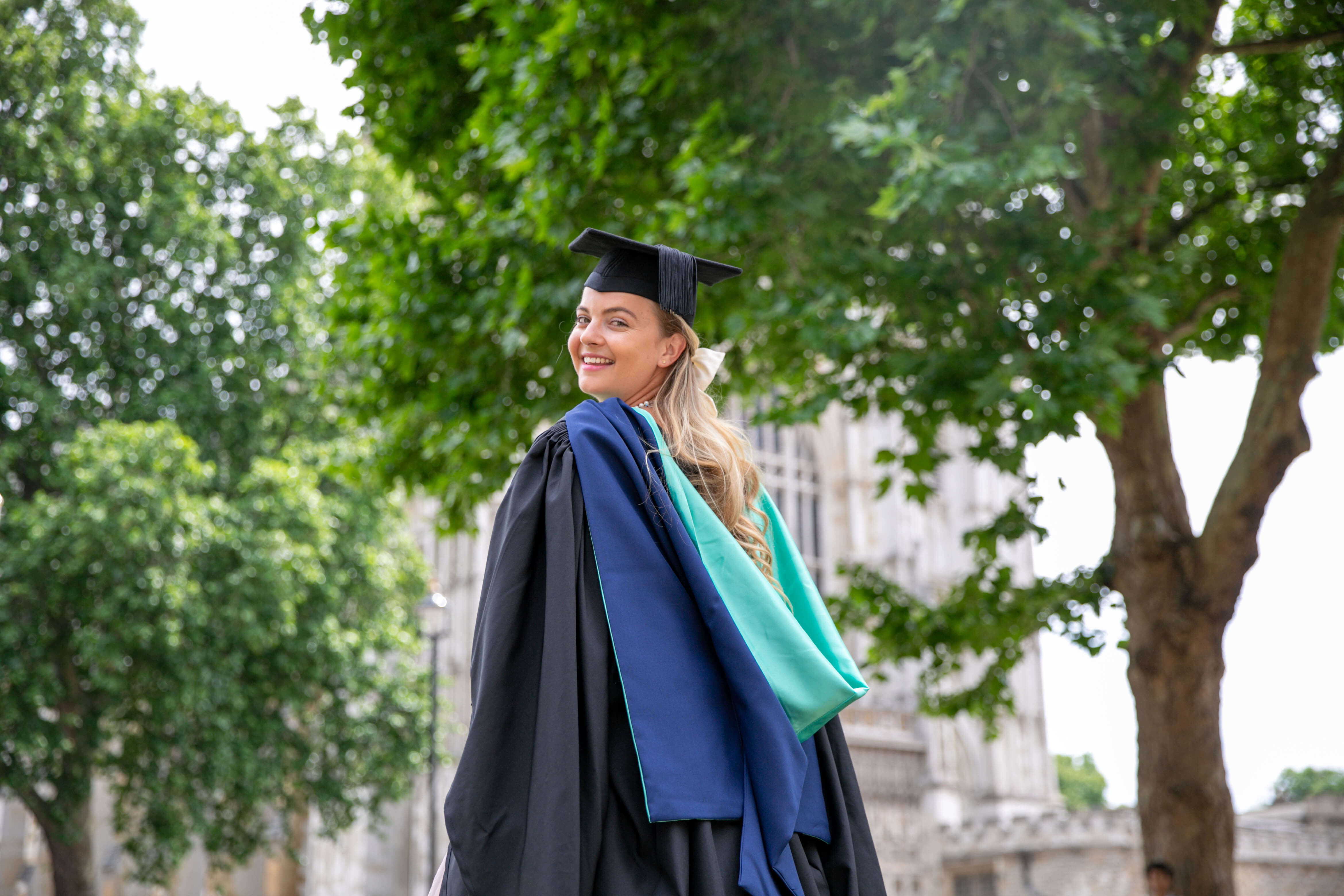 Arden student in front of trees