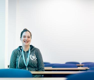 Photo of Arden student, Jade, in an empty classroom