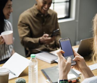 3 people sitting around a table working