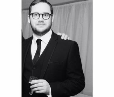 Black and white photo of an Arden student in a suit