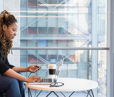 woman working on a laptop on a coffee table