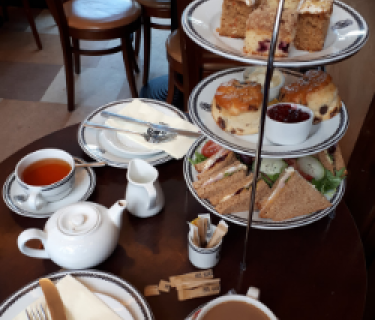 Three tiered afternoon tea tray on a table
