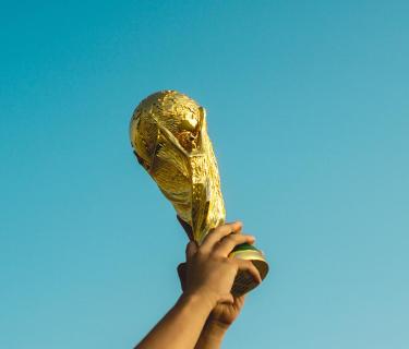 Hands holding the World Cup aloft