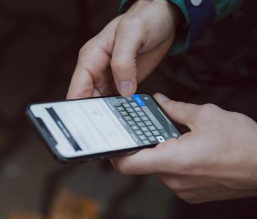 Hands holding smartphone