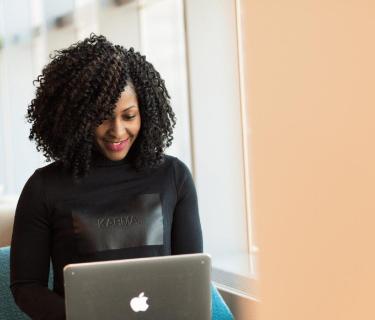 Smiling woman working on laptop