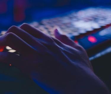 Hand typing on computer keyboard