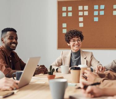 Group of work colleagues smiling in a meeting