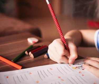 Child writing at desk