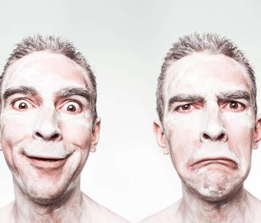 Image of man making happy face then sad face