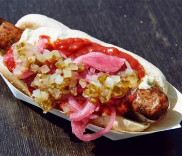 Photo of a hot dog with many toppings