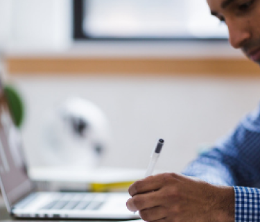man writing at a desk
