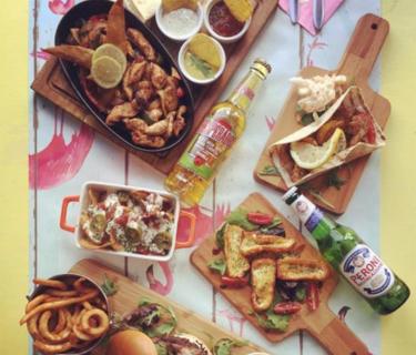 A restaurant table with food and drinks on it