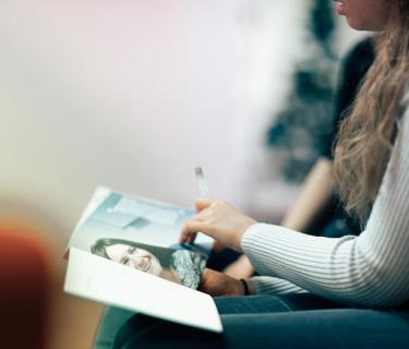 Woman looking at a book in her lap