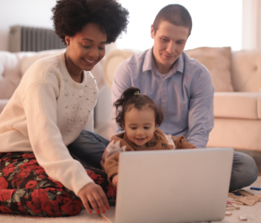 family sat around laptop