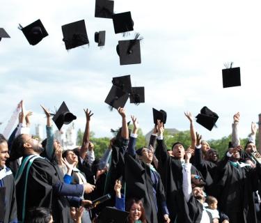 graduates throw their hats in the air
