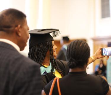 a student at graduation with their family