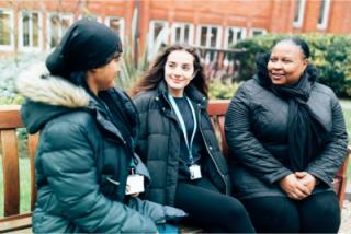 Arden University students sitting in study centre garden
