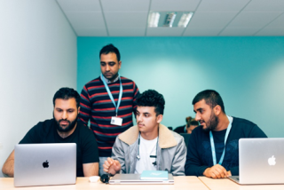 Arden University students on laptops at Birmingham study centre